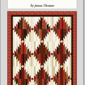 A quilt with red and white designs on it.
