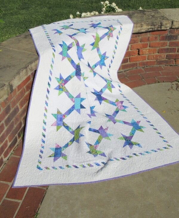A quilt that is on the ground outside.